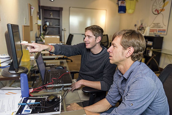 Jason Koop and second-year CTS coach Davis Bentley look at data from a recent workout.