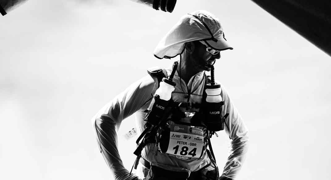 At the end of day 1, a racer stands at the entrance to the “cool-down” tent.
