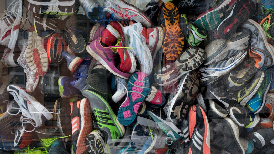 A detail of old trainers are stacked in the window of a sports accessories shop, on Milady Horakove street, Holesovice district, Prague 7, on 18th March, 2018, in Prague, the Czech Republic. (Photo by Richard Baker / In Pictures via Getty Images)