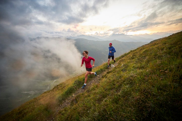 Man and woman running in the mountains