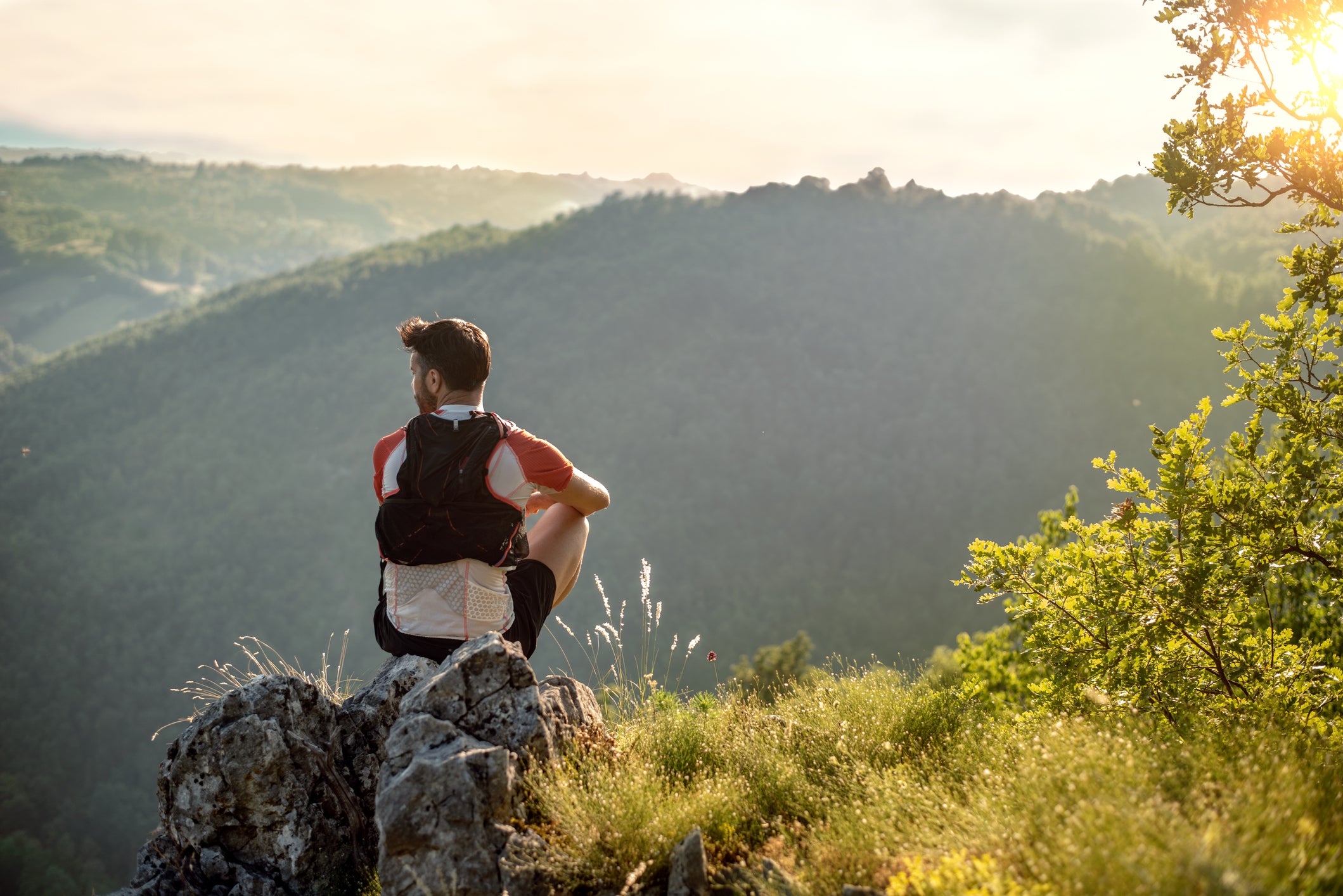 Trail runner succeeding by reaching the top of a mountain