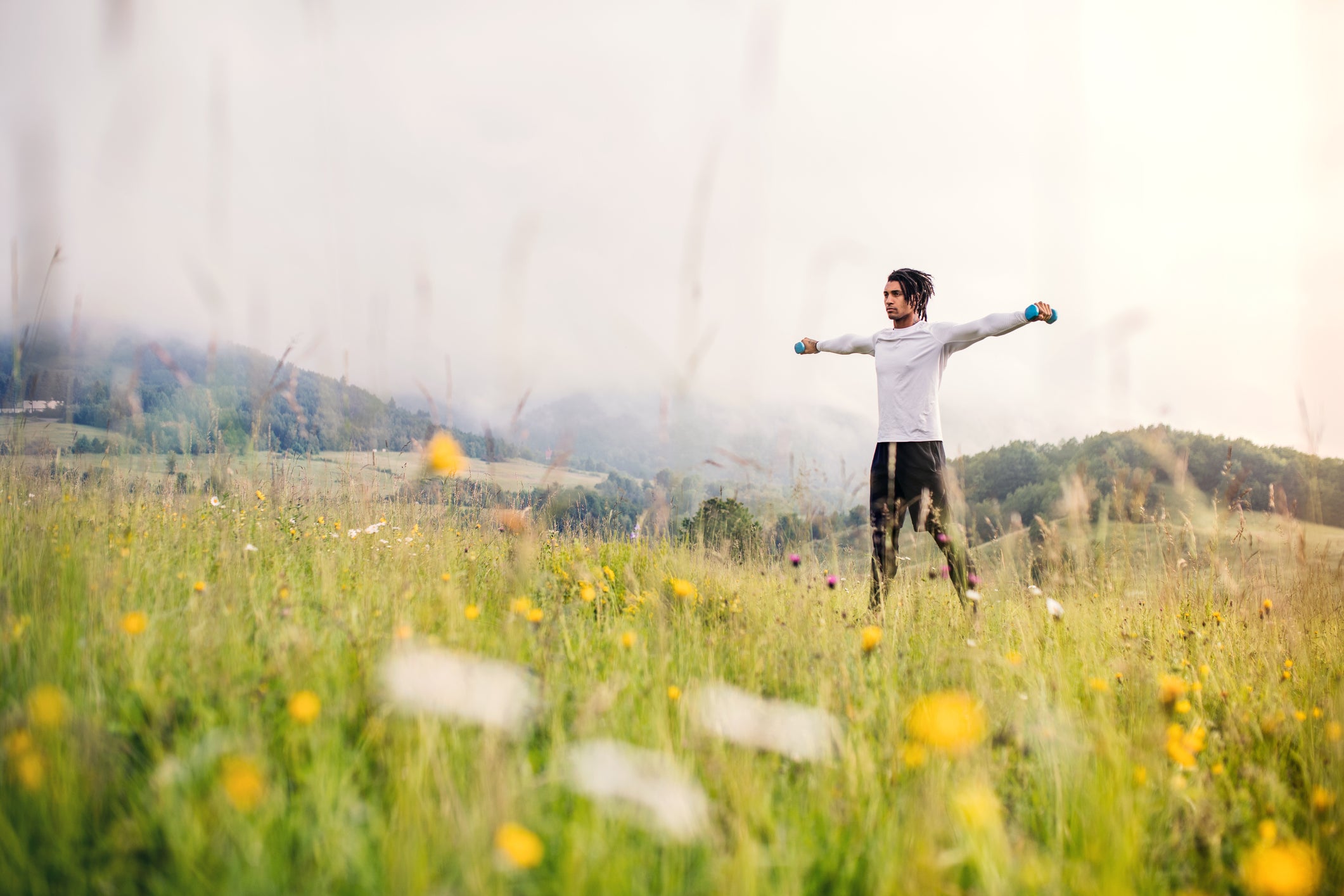 A fit and active man on meadow, doing sport.
