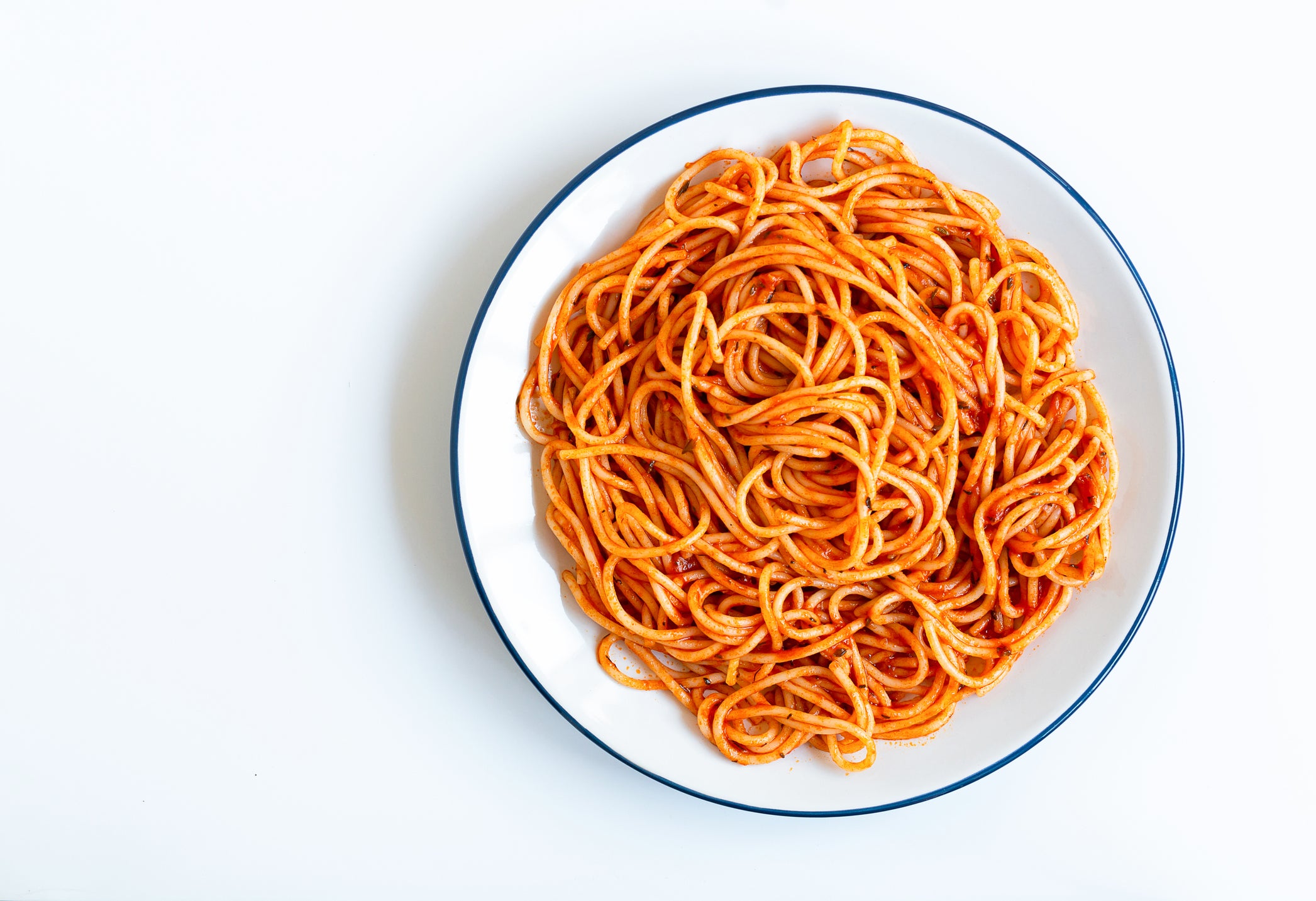 Tomato spaghetti on white background, directly above