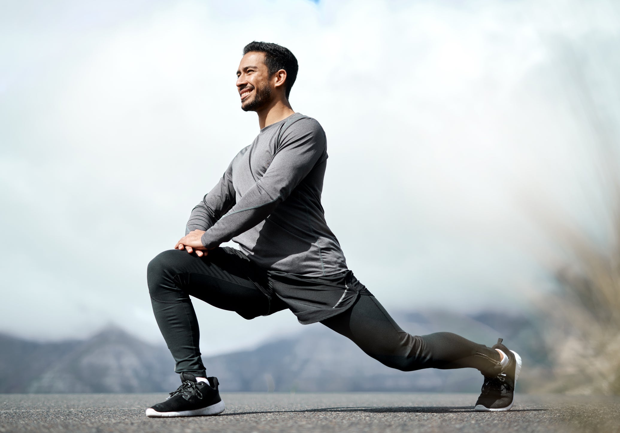 Full length shot of a handsome young man stretching before exercising outdoors alone