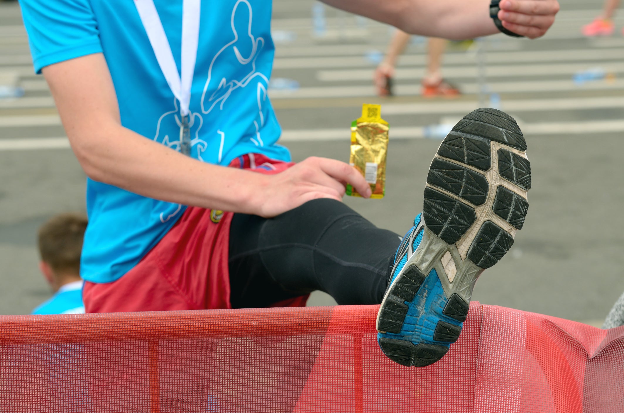 An athlete warms up his feet.She's resting after the marathon.