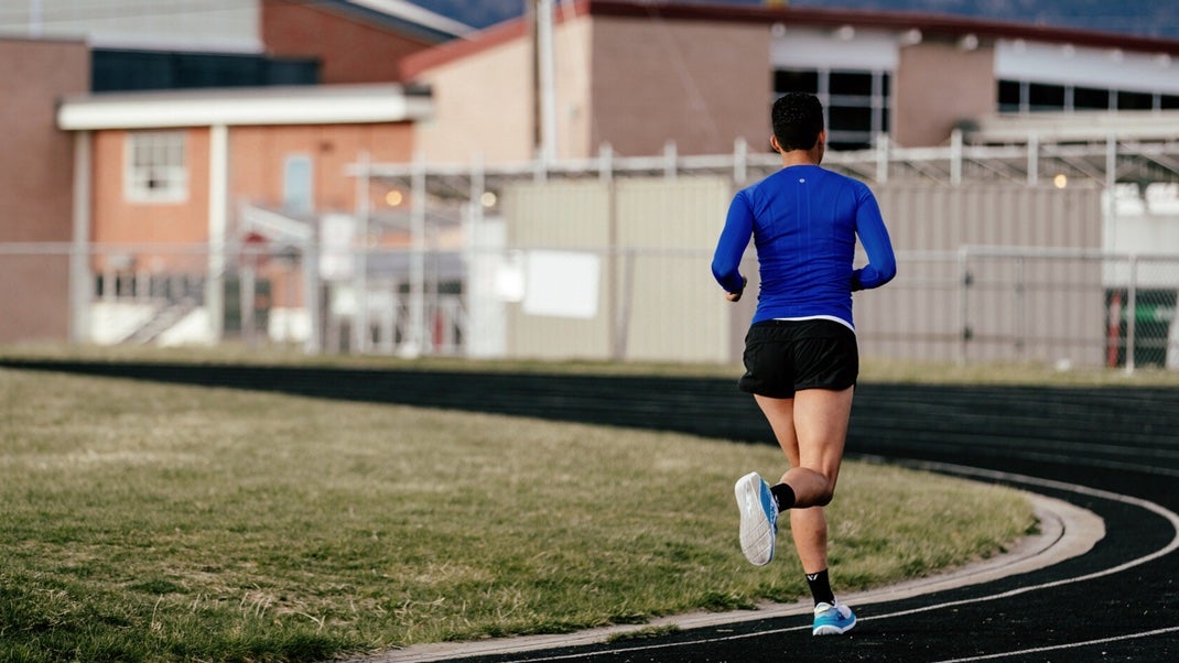 Person running on a black track