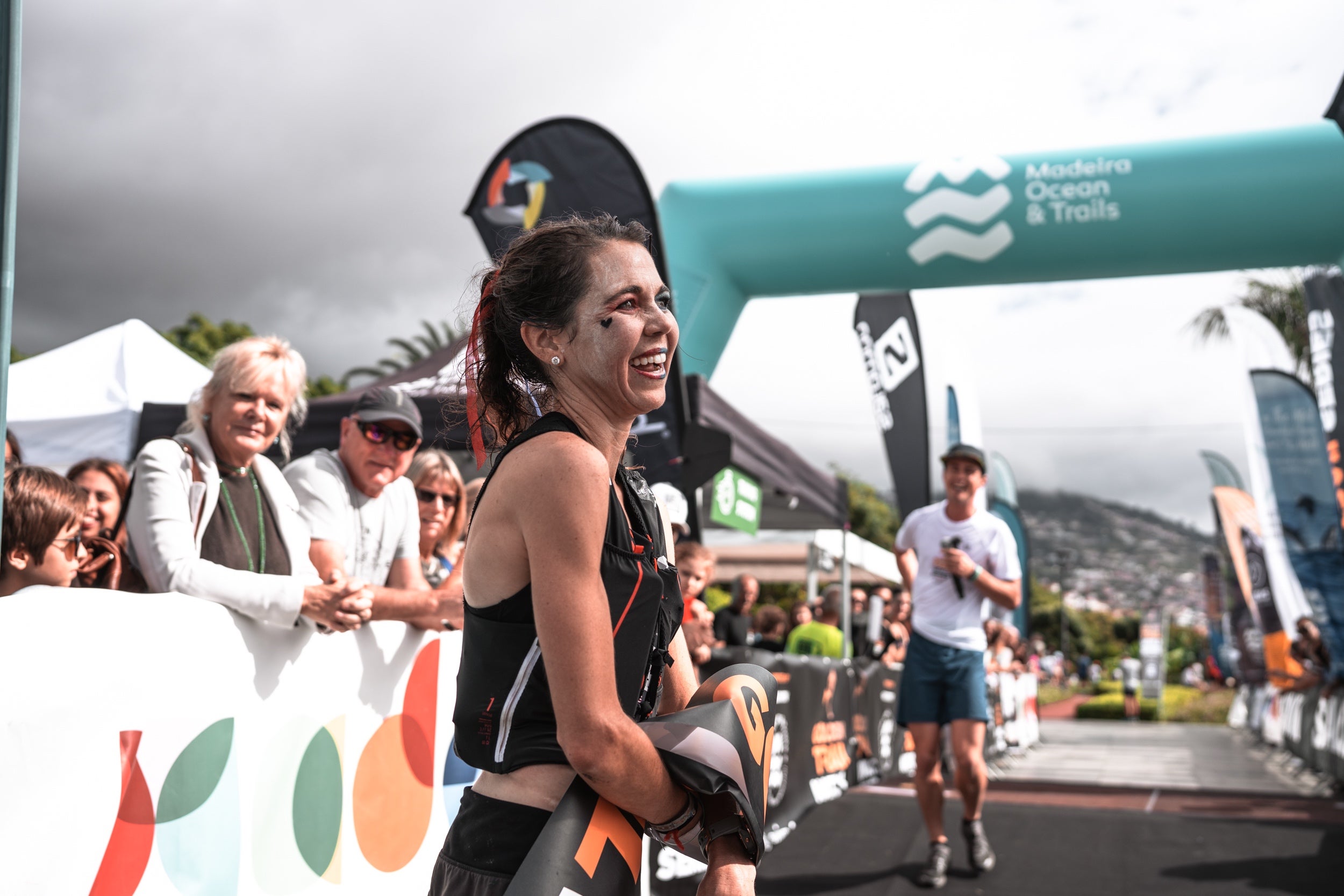 woman finishes a race and smiles