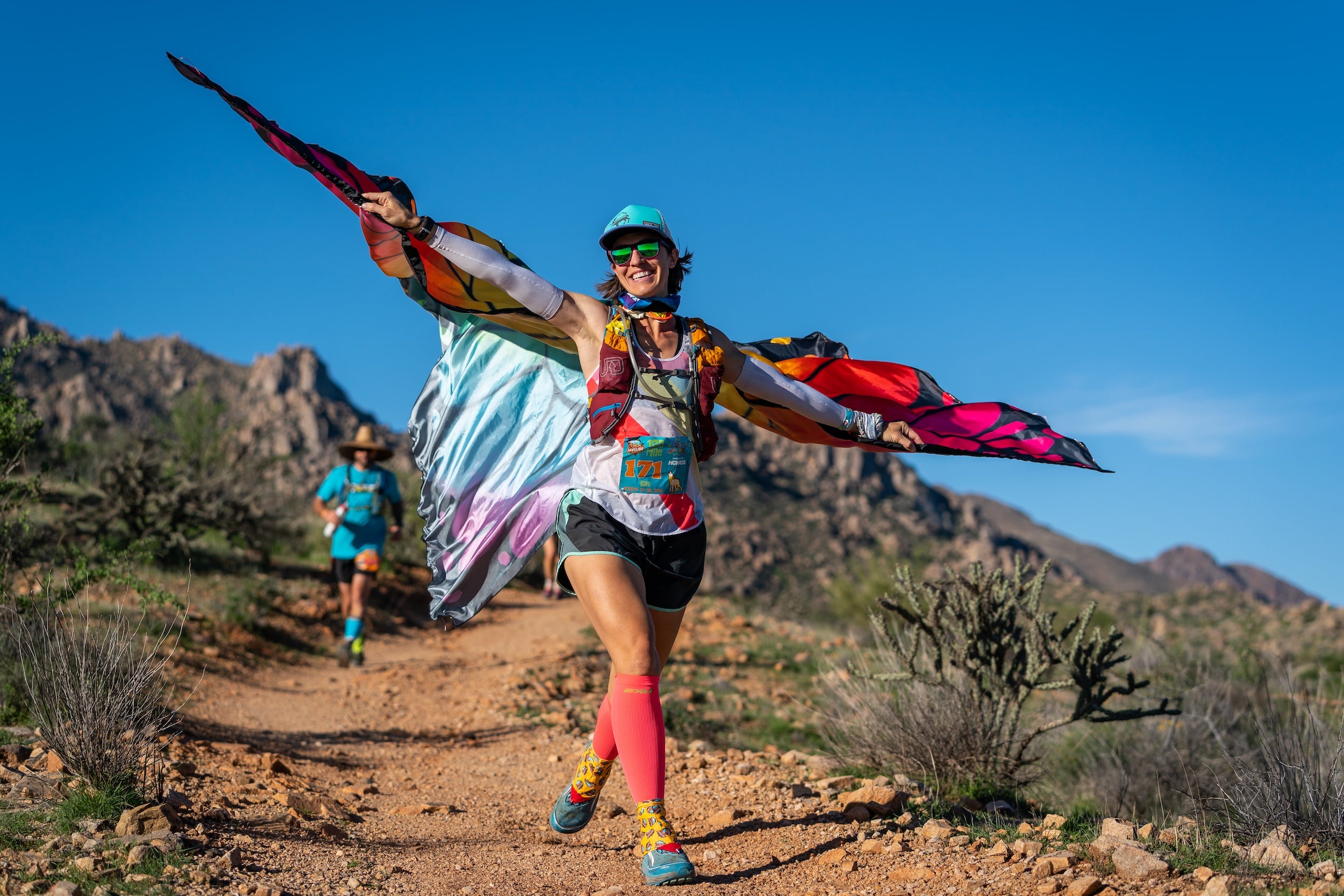 runner in the desert with arms outstretched