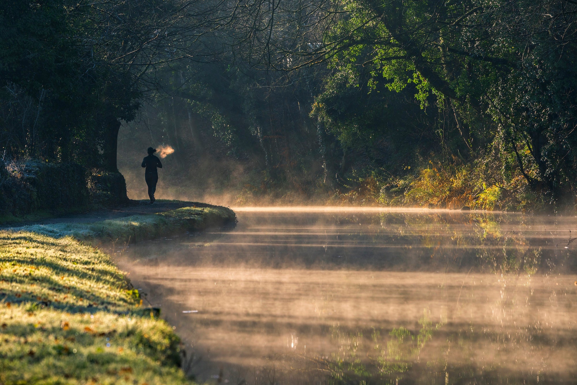 runner in a cold morning along a river