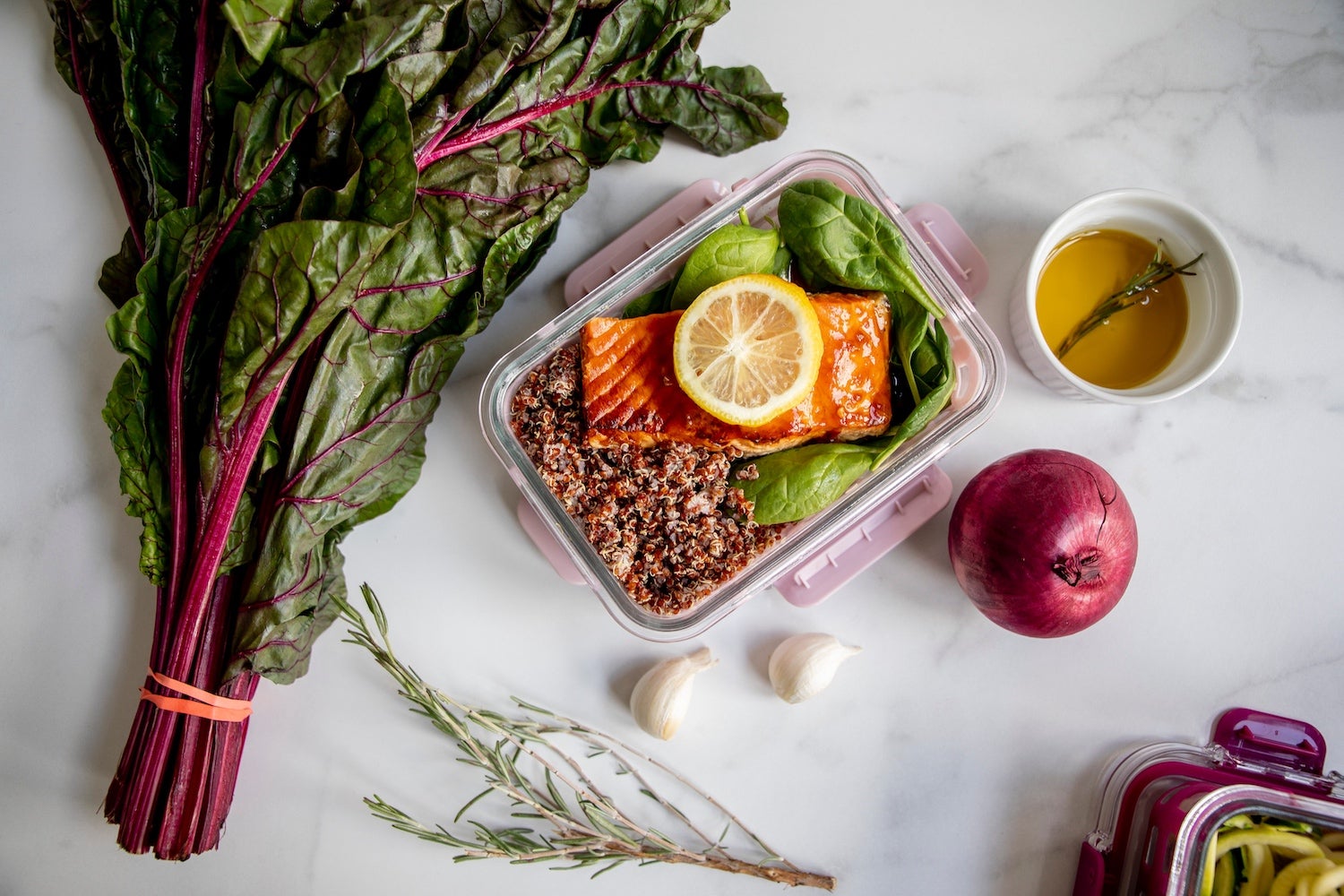 aerial shot of healthy fruits and veggies and fish on a white table.