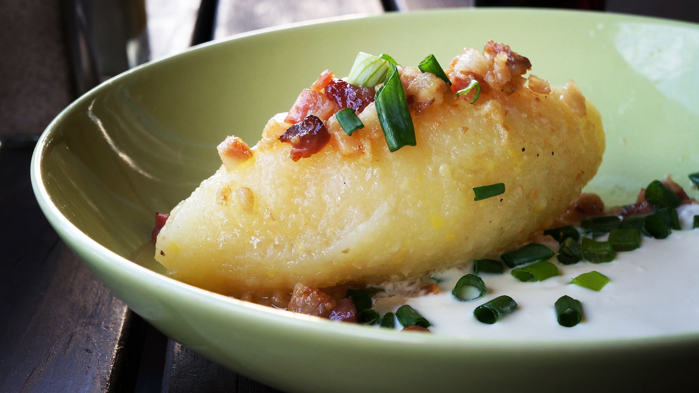a lithuanian dumpling plated with bit of meat and onions