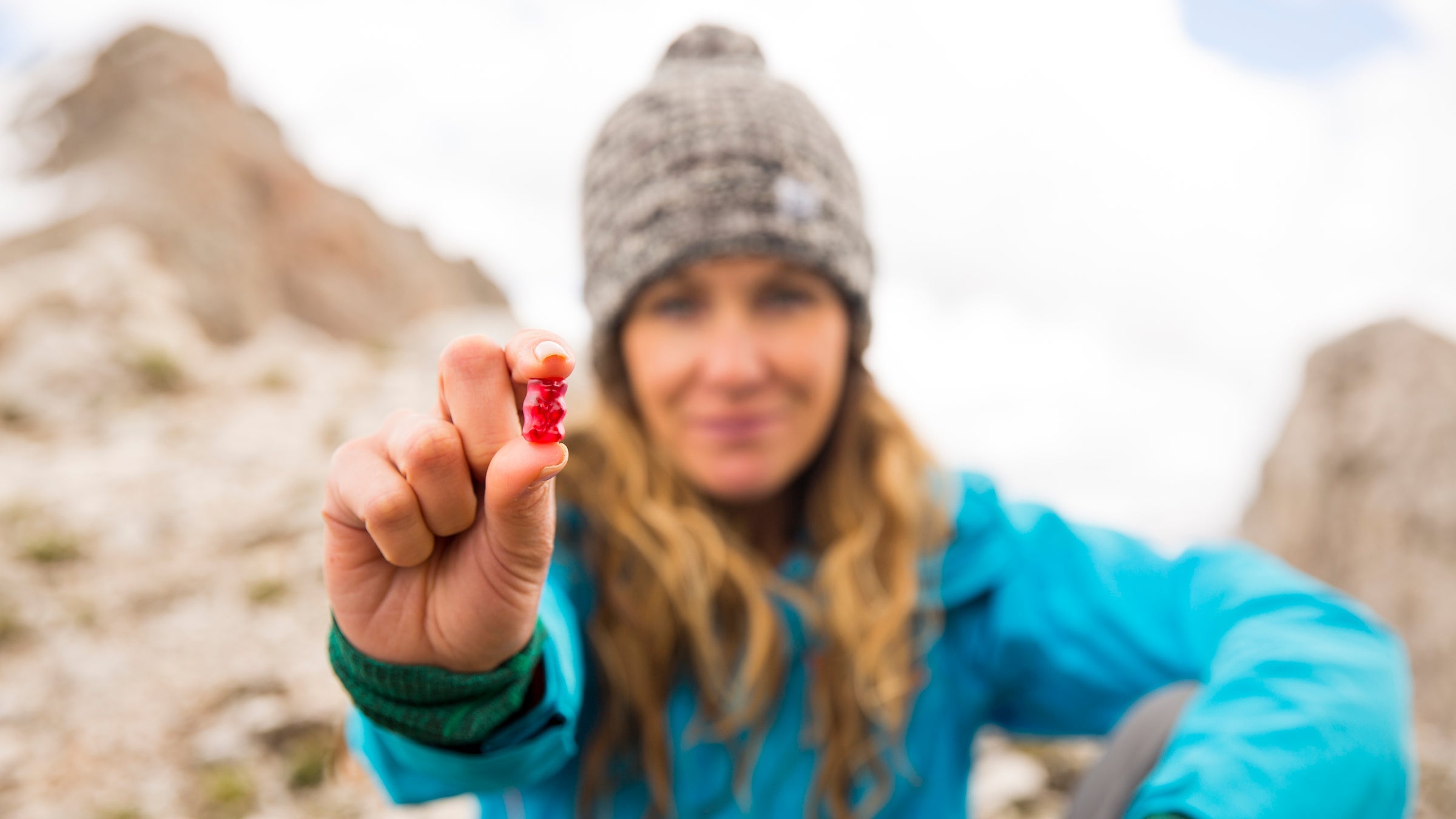 woman holding gummy bear outdoors